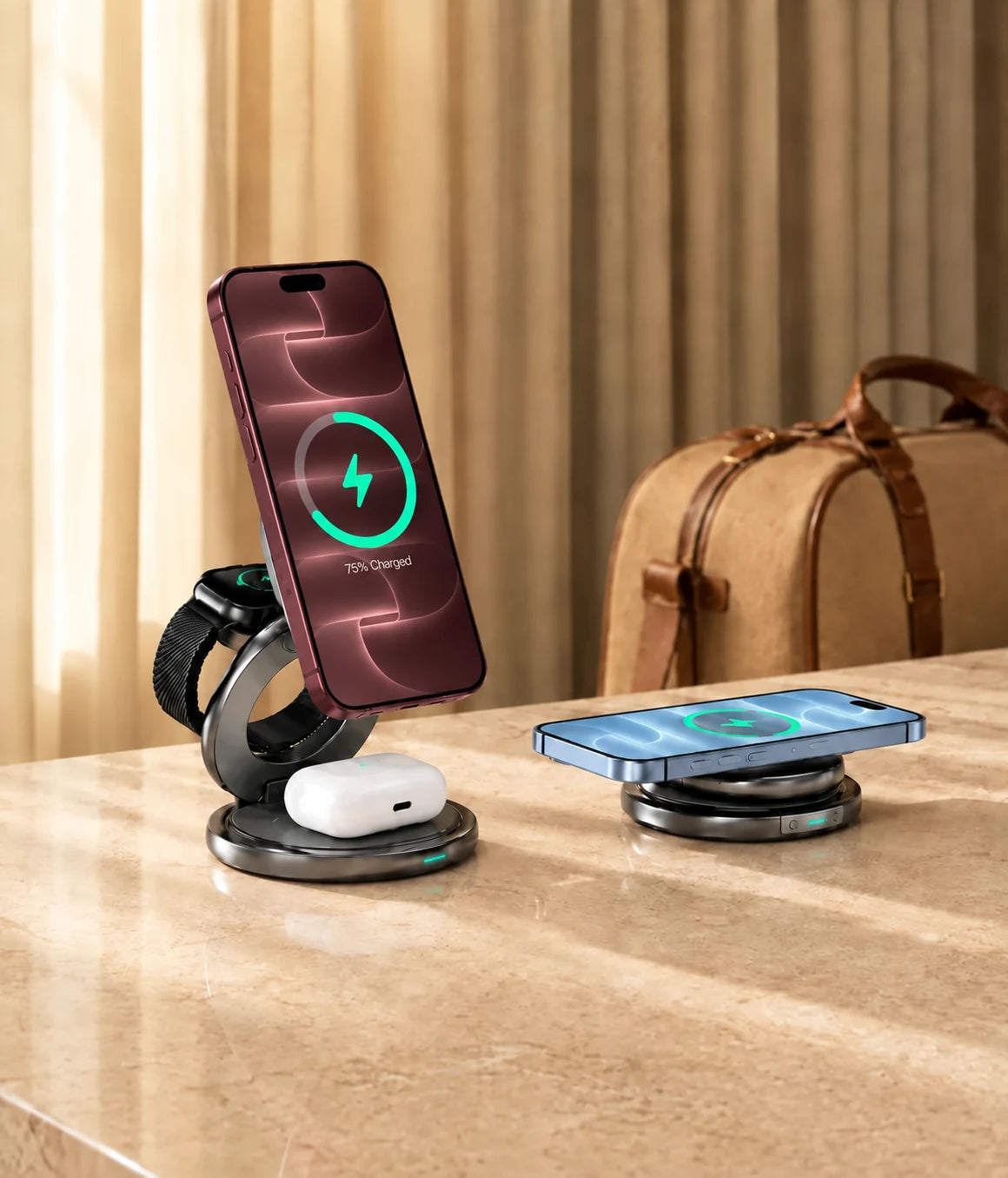 Burgundy and Glacier iPhones charging on foldable wireless chargers beside a travel bag.