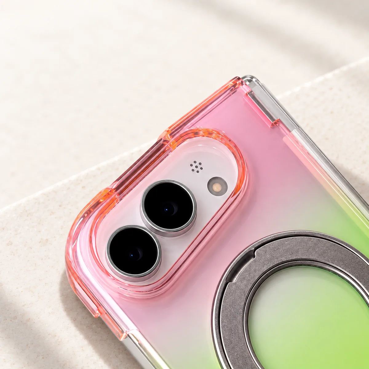 Close-up of the raised pink translucent oval edge around two rear camera lenses on a silver phone.