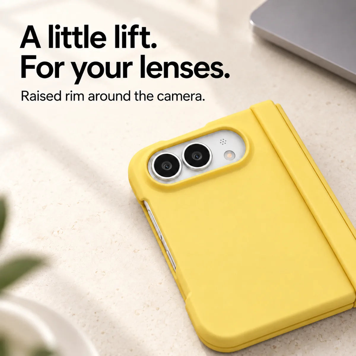 Close-up of the raised Yellow camera rim on a matte iPhone Ultra case resting on a light desk. #color_Solstice Yellow